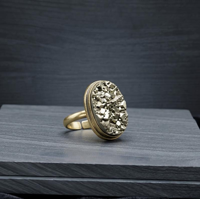 Natural Pyrite crystal ring featuring a polished Pyrite gemstone set in an adjustable band. This elegant crystal ring showcases Pyrite's signature metallic golden shine, making it a stylish accessory associated with abundance, confidence, and protection.